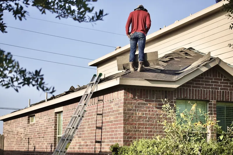 Professional roofer working on a residential roof in Geneseo